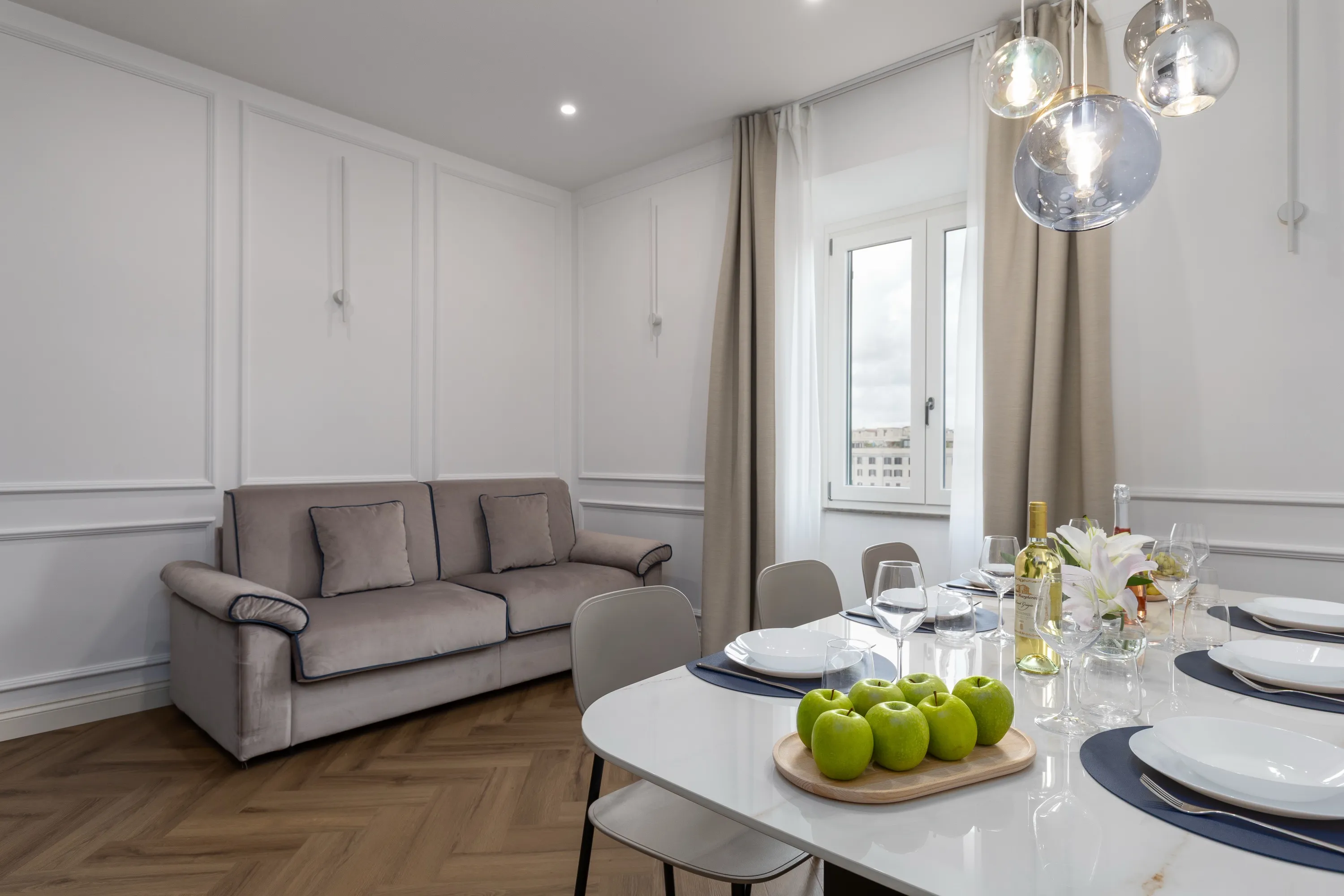 Living room and dining table of one of our apartments by the Colosseum